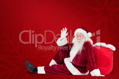 Composite image of santa sits leaned on his bag and waves