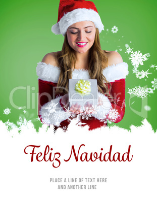 Composite image of pretty girl in santa costume holding gift box