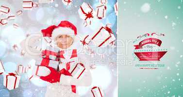 Composite image of festive woman holding gifts