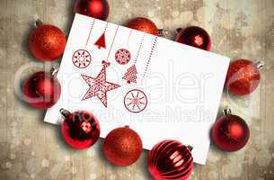 Composite image of hanging red christmas decorations