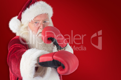 Composite image of santa claus punches with his right