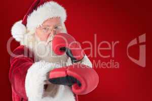 Composite image of santa claus punches with his right
