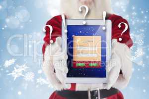 Composite image of santa presents a tablet pc