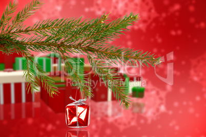 Composite image of red christmas decoration hanging from branch