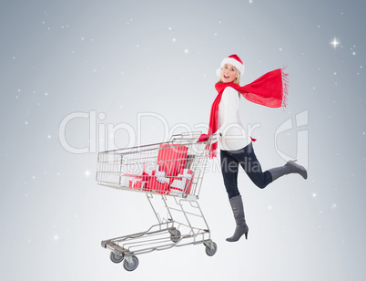 Festive blonde pushing trolley full of gifts