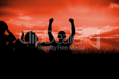 Composite image of silhouettes of football supporters