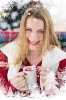 Composite image of smiling blonde in winter clothes holding mug