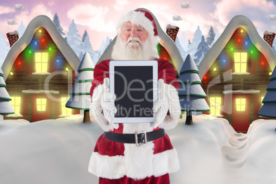 Composite image of santa presents a tablet pc