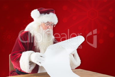 Composite image of santa reads a long list