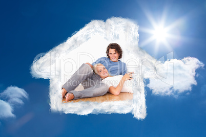 Composite image of young couple sitting together