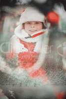 Composite image of festive little boy smiling at camera