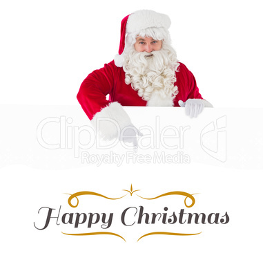 Composite image of joyful santa claus presenting sign