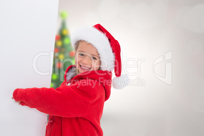 Composite image of festive little girl showing poster