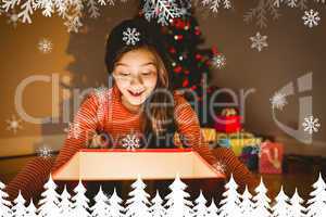 Composite image of little girl opening a glowing christmas gift