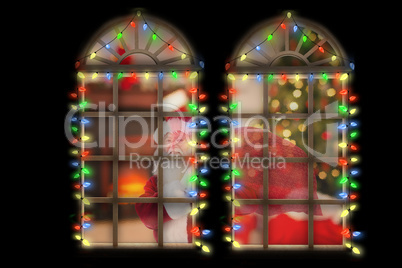 Composite image of santa carries his red bag and smiles