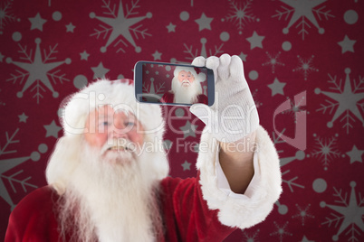 Composite image of santa taking a selfie on phone