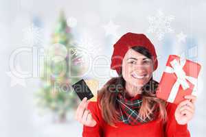 Composite image of smiling brunette holding gift and cards
