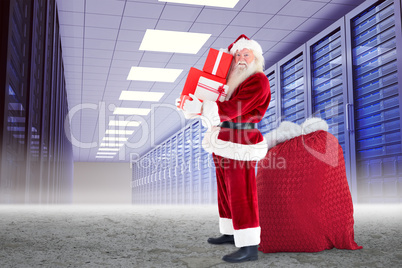 Composite image of santa claus carrying pile of gifts