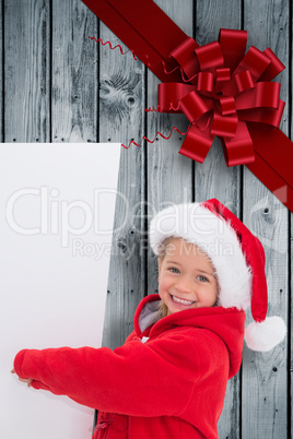 Composite image of festive little girl showing poster