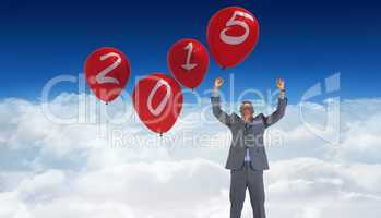 Composite image of happy businessman cheering