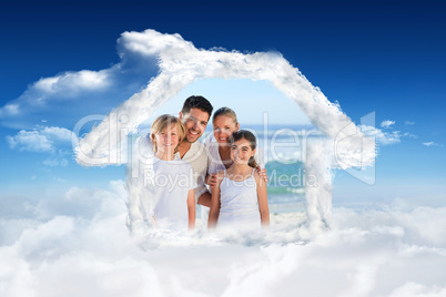 Composite image of portrait of a cute family at the beach