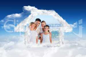 Composite image of portrait of a cute family at the beach