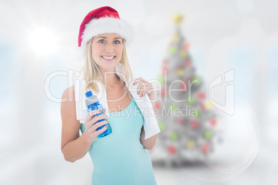 Composite image of festive fit blonde smiling at camera