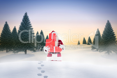 Composite image of santa carrying gifts in the snow