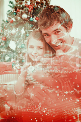 Composite image of father and little girl playing with christmas