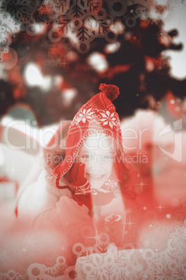 Composite image of festive little girl in hat and scarf