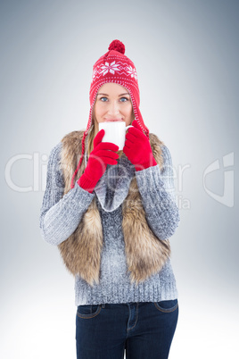 Woman in winter clothes holding a mug