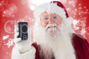 Composite image of santa claus shows a smartphone