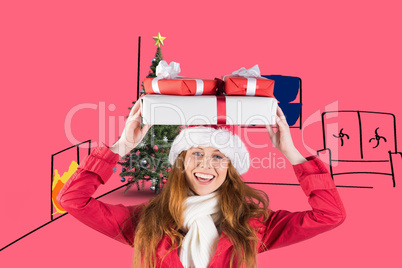 Composite image of festive redhead holding pile of gifts