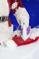 Composite image of father christmas is ironing his hat