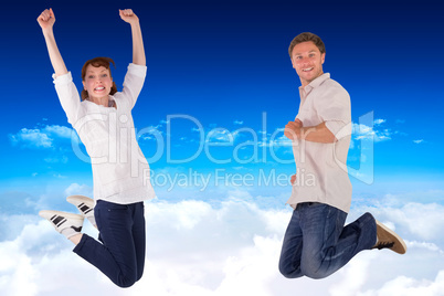 Composite image of couple jumping in the air