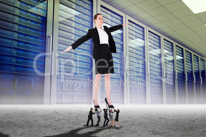 Composite image of business people supporting boss