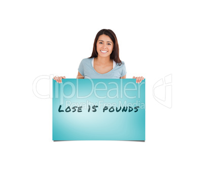 Composite image of attractive woman holding a  board