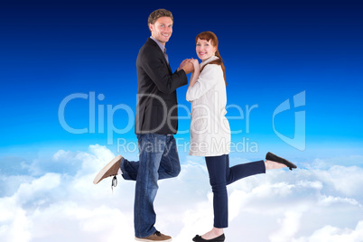 Composite image of smiling couple with raised legs
