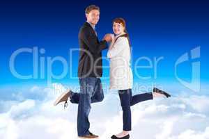 Composite image of smiling couple with raised legs