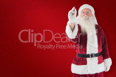 Composite image of santa writes something with a pen Composite image of santa writes something with a pen