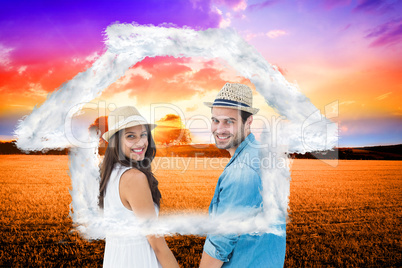 Composite image of happy hipster couple holding hands and smilin