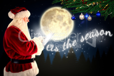 Composite image of santa uses a tablet pc