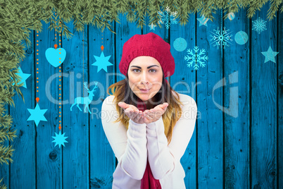 Composite image of brunette in winter clothes with hands out