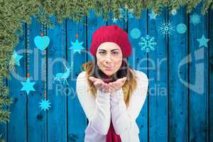 Composite image of brunette in winter clothes with hands out