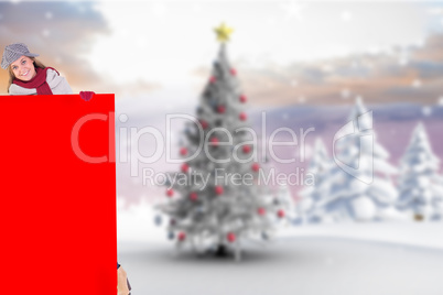 Composite image of happy blonde in winter clothes showing card