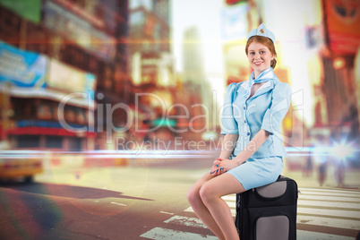 Composite image of pretty air hostess smiling at camera