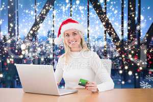 Composite image of festive blonde shopping online