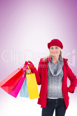 Blonde in winter clothes holding shopping bags