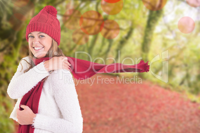 Composite image of happy blonde in winter clothes