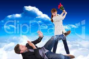 Composite image of woman throwing roses at man